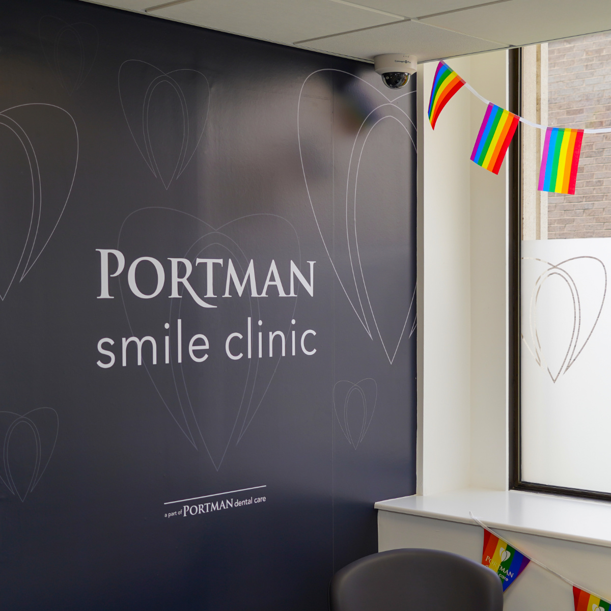 Wall mural and frosted window vinyl featuring Portman Dental branding at Portman Smile Clinic Ilkley
